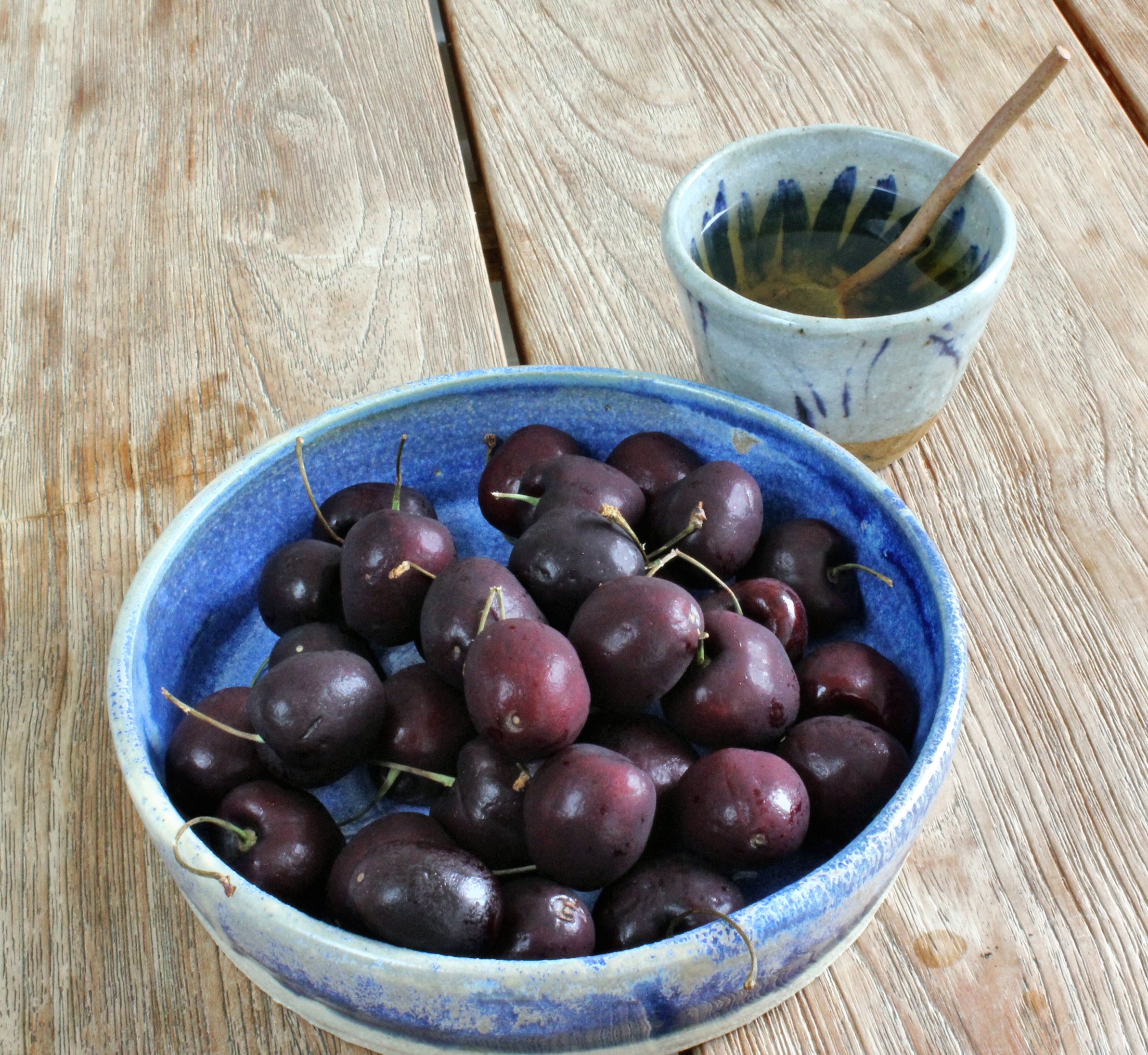 Japanese pottery blue plate with cherries and tea cup with spoon