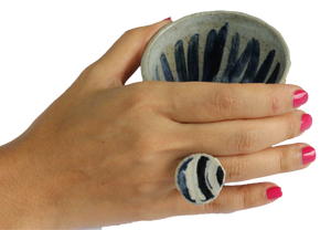 Japanese pottery tea cup and ring on hand