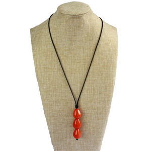 Necklace, handmade, sustainable tagua nut, orange, stand