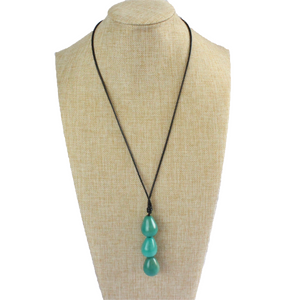 Necklace, handmade, sustainable tagua nut, turquoise, stand