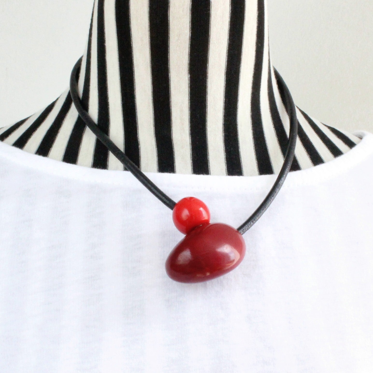 Handmade necklace, tagua nut, sustainable, magnet, burgundy, stand